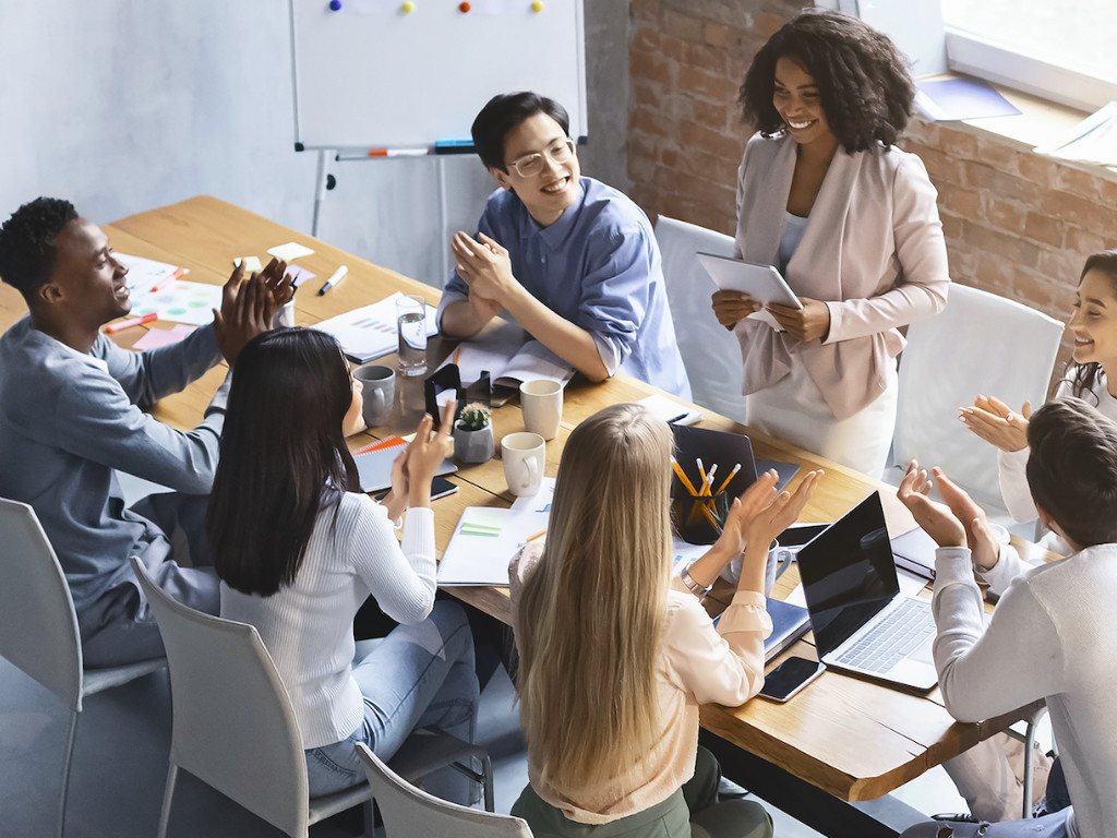 People working on tone of voice round desk