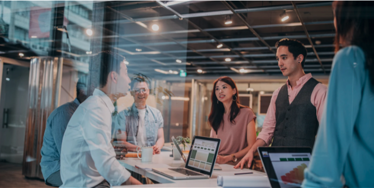 People gathered around laptop