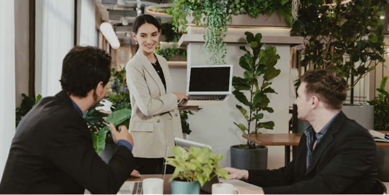 Lady displaying work on laptop