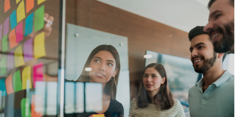 People gathering around post-it board