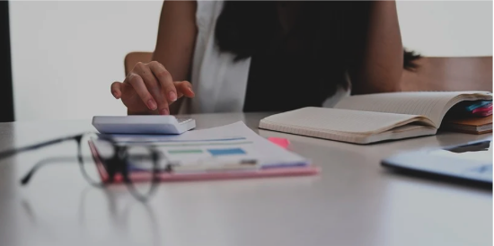 Lady at desk researching in books